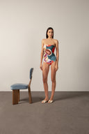 Model wearing the Organic Floral Strapless Swimsuit front with unique color styled for a beach look