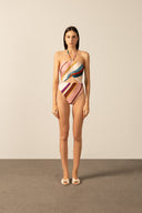 Model wearing the Organic Stripes Halterneck Swimsuit  unique color front from the HS25 with 85% Polyamide 15% Elastane styled for a beach look.   