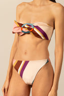 Model wearing the Organic Stripes High-Leg Strapless Bikini unique color detail from the HS25 with 85% Polyamide 15% Elastane styled for a beach look.   