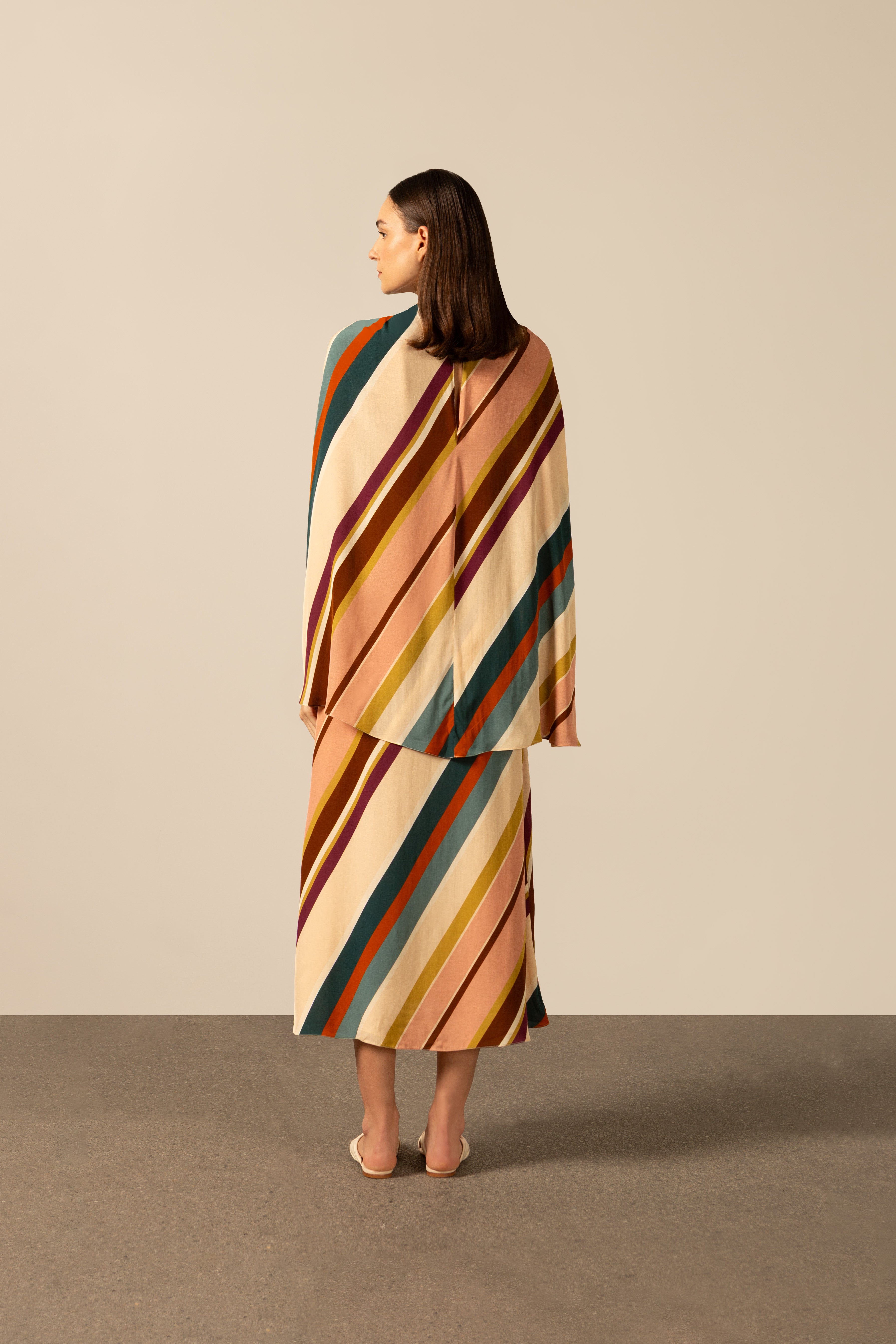 Model wearing the Organic Stripes Midi Dress unique color back from the HS25 with 100% Viscose styled for a lunch look.  
