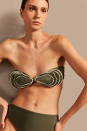Model wearing the Oyster Hot Pants 3D Bikini Detail showcasing its Croco Green color on 85% polyamide 15% spandex fabric.