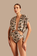 Model wearing the Oysters High-Leg Bodysuit showcasing the close up of it's deep neckline piece with Oysters Print, on a stretchy fabric.