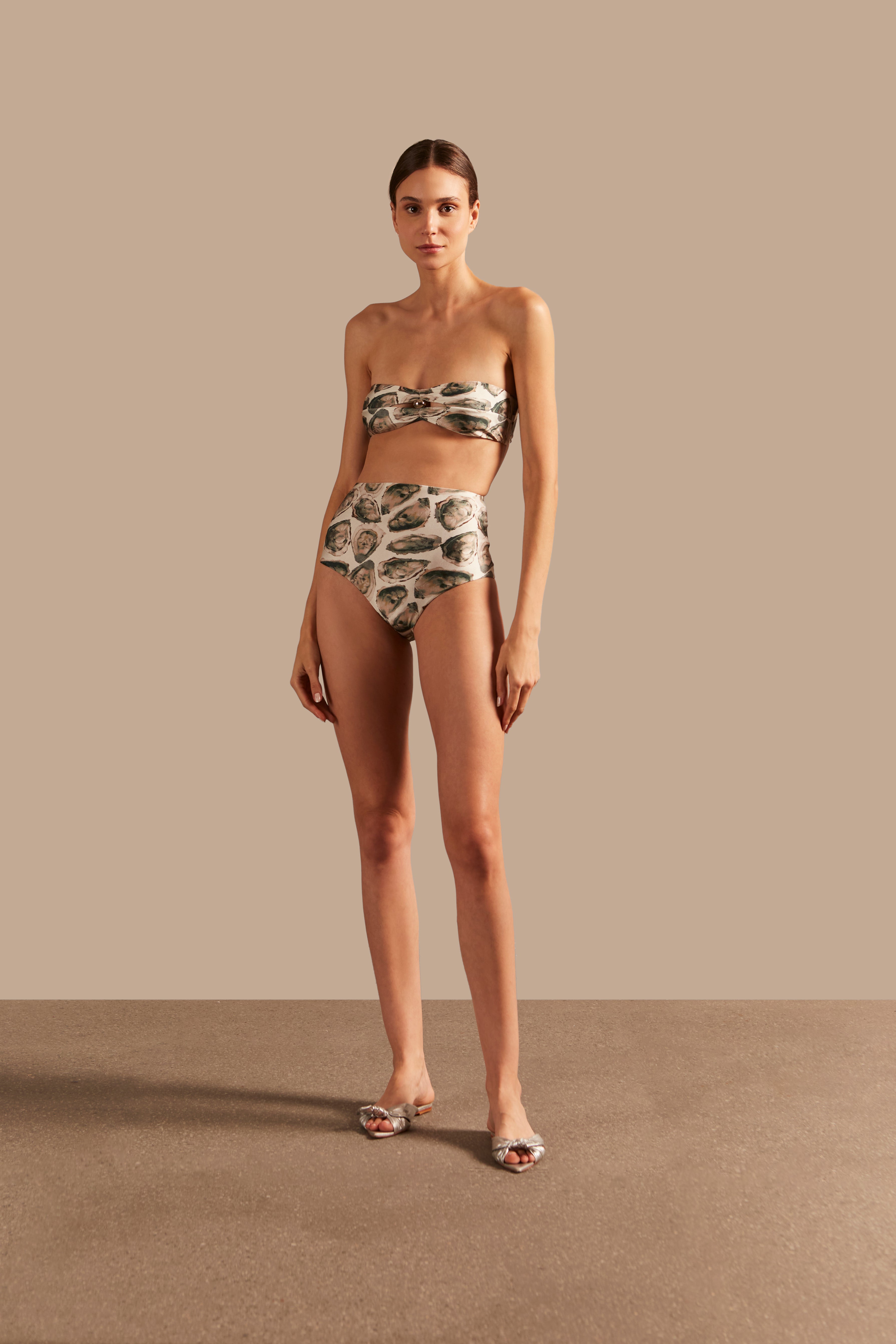 Model wearing the Oysters High-Waisted Bikini showcasing the front of it's retro inspiration, with Oysters Print, on a stretchy fabric.