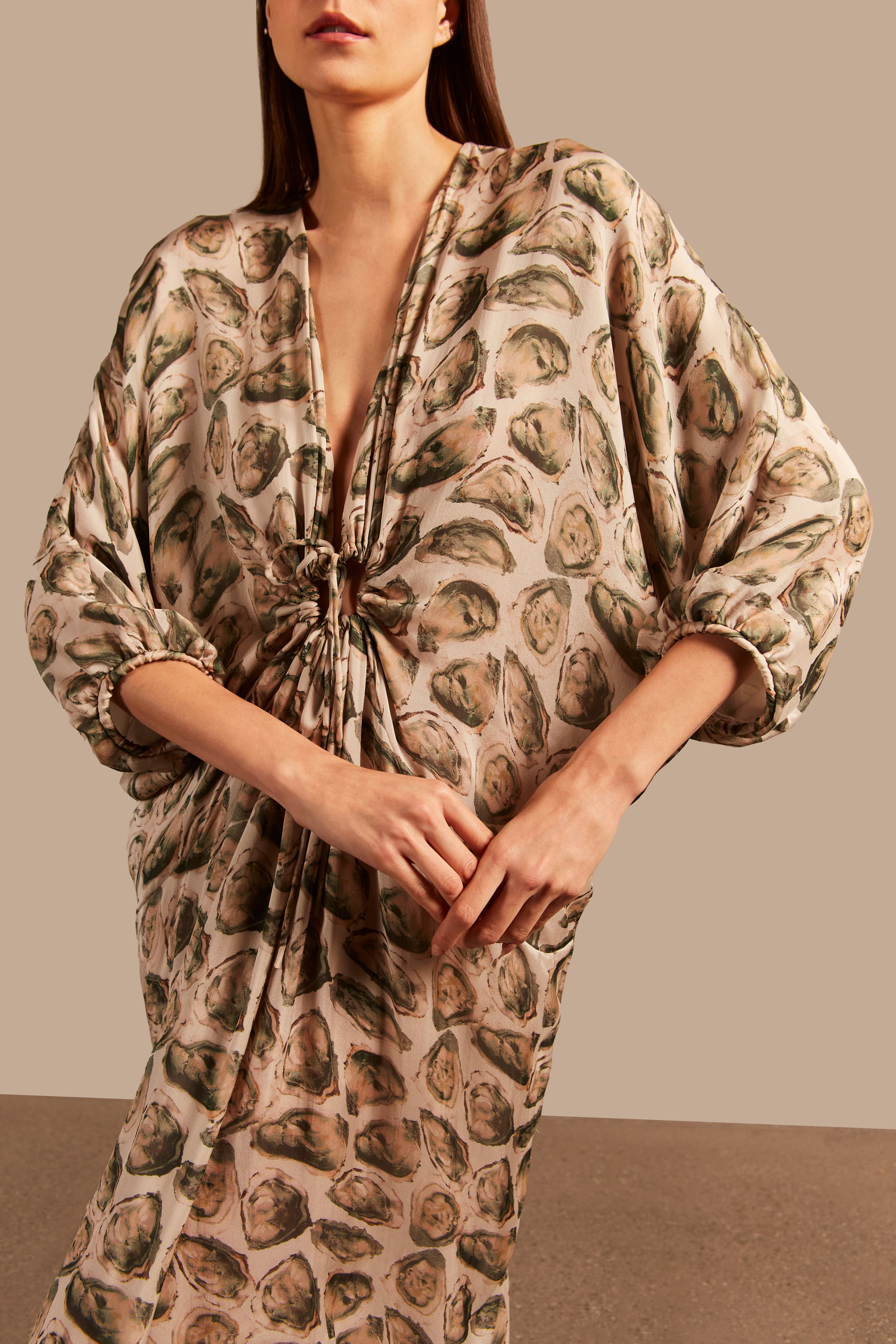 Model wearing the Oysters Long Kaftan With Knot showcasing the close up of it's vintage style, with Oysters Print, on a silk fabric.