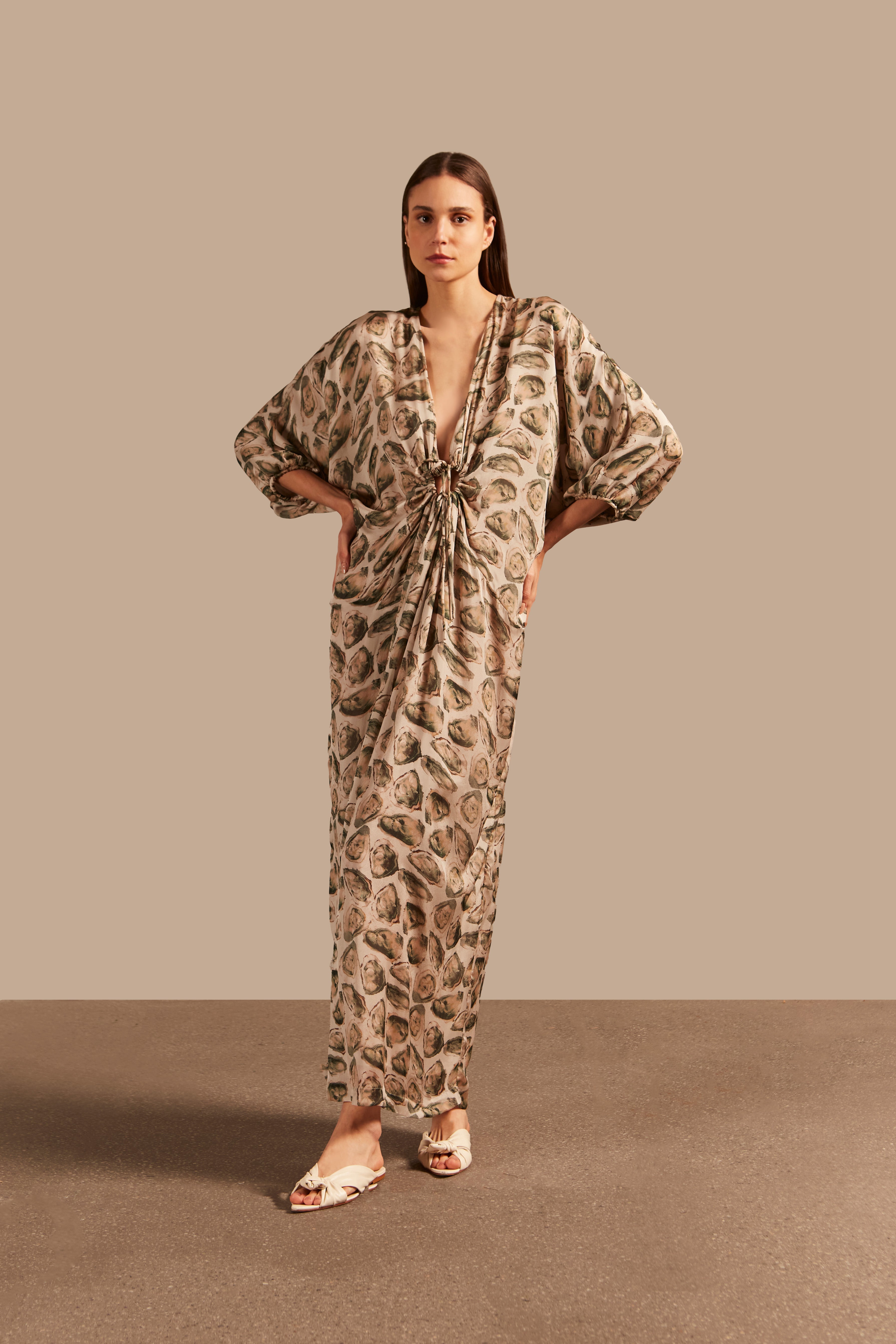 Model wearing the Oysters Long Kaftan With Knot showcasing the front of it's vintage style, with Oysters Print, on a silk fabric, used for a evening look.