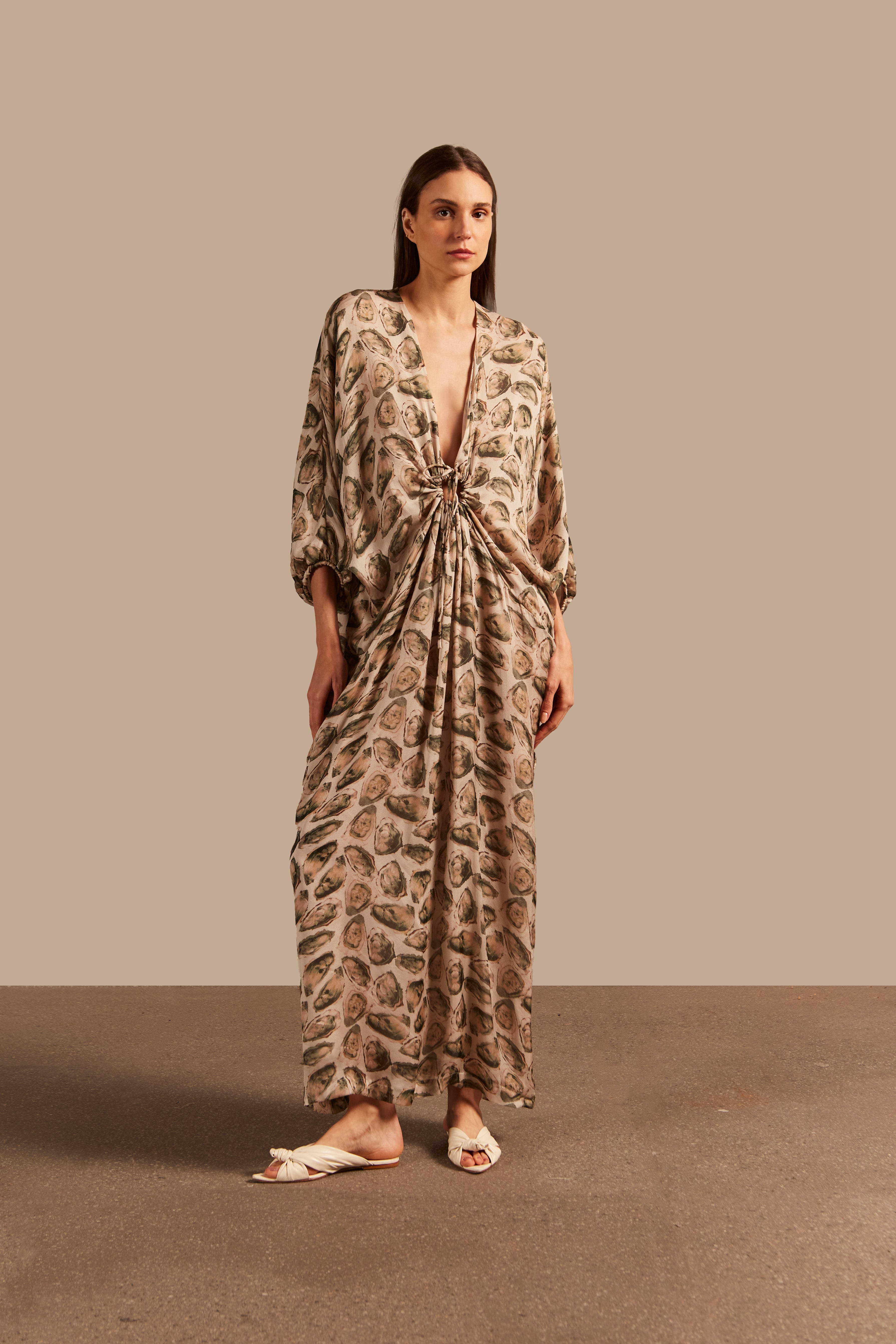 Model wearing the Oysters Long Kaftan With Knot showcasing the front of it's vintage style, with Oysters Print, on a silk fabric.