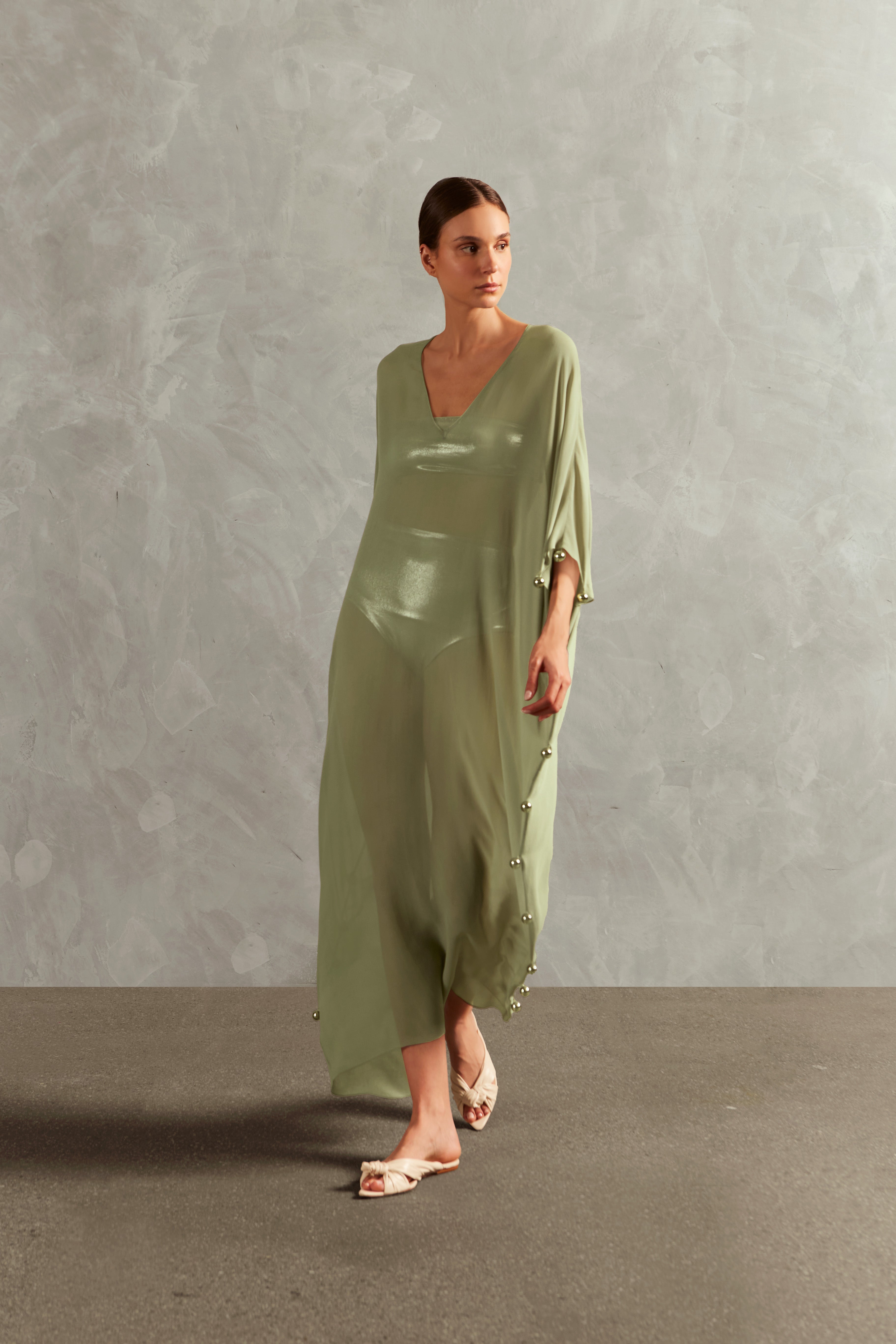 Model wearing the Oysters Solid Long Kaftan With Pearls Front showcasing its sophisticated Green print with Pearls Applications on 100% viscose fabric, styled for a resortwear look.