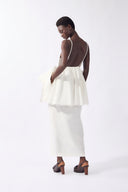 Model wearing the Peplum Maxi Dress back color off white, made from 98% cotton 2% elastane, styled for resort look 