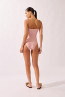 Model wearing the Petal Appliqué Swimsuit back color unique, made from 85% polyamide 15% elastane, styled for a beachwear look