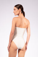 Model wearing the Petal Strapless Swimsuit back color off white, made from 85% polyamide 15% elastane, styled for a beachwear look
