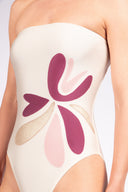 Model wearing the Petal Strapless Swimsuit detail color off white, made from 85% polyamide 15% elastane, styled for a beachwear look