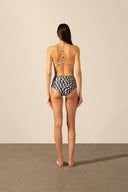 Model wearing the Pois High-Waisted Triangle Bikini back styled for a beach look
