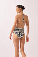 Model wearing the Pois High-Waisted Triangle Bikini back color off white, styled for a beach look