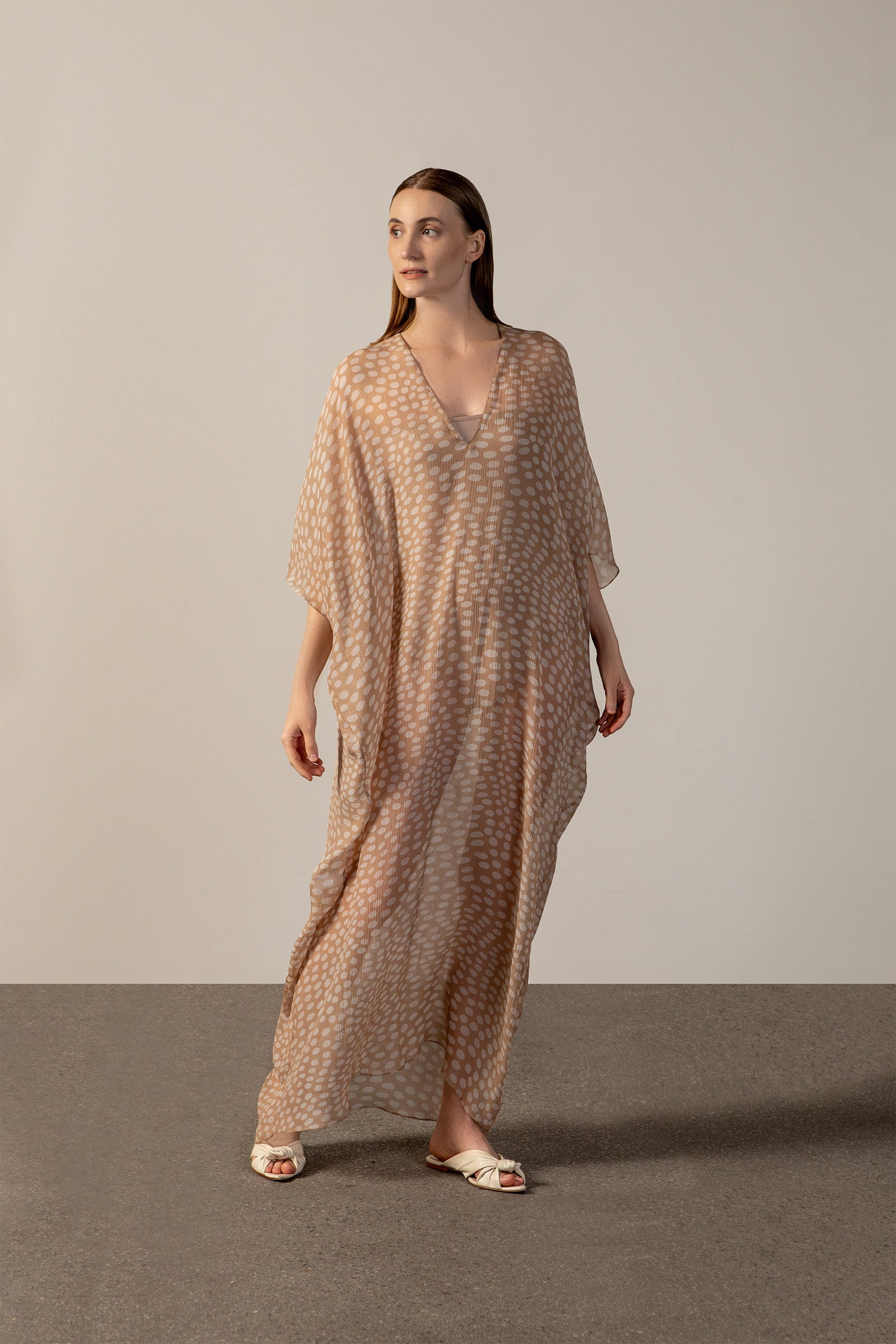 Model wearing the Pois Long Kaftan front beige styled for a resort look