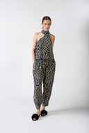 Model wearing the Pois One-Shoulder High-Neck Jumpsuit navy front from the HS25 with 100% viscose styled for a drinks at sunset look.    