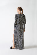 Model wearing the Pois Plunge-Neck Maxi Dress navy back from the HS25 with 100% viscose styled for a date look.    