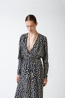 Model wearing the Pois Plunge-Neck Maxi Dress navy detail from the HS25 with 100% viscose styled for a date look.    