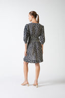Model wearing the Pois Plunge-Neck Short Dress navy back from the HS25 with 100% viscose styled for a drinks at date look.    