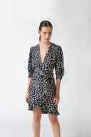Model wearing the Pois Plunge-Neck Short Dress navy detail from the HS25 with 100% viscose styled for a drinks at date look.    