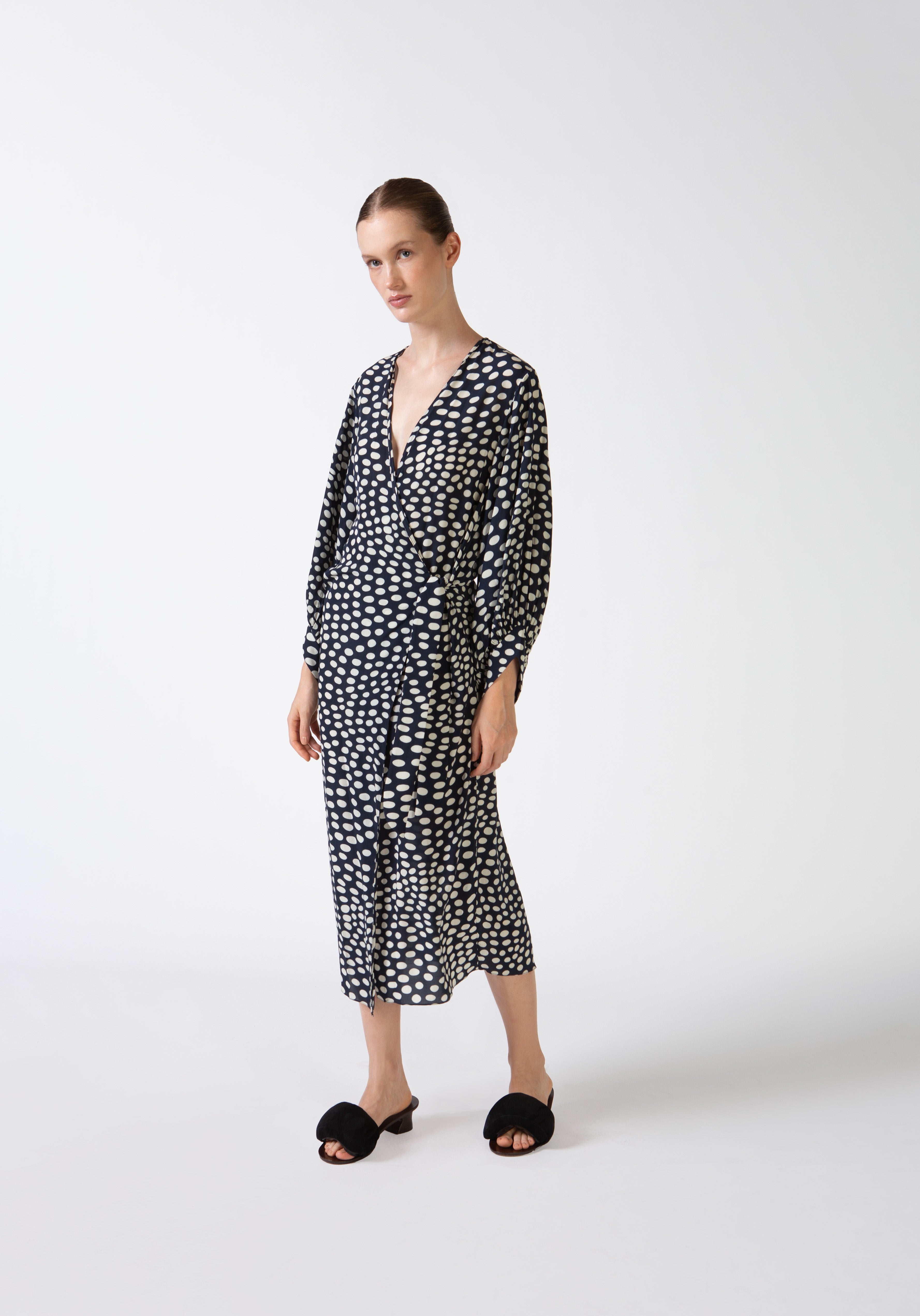 Model wearing Pois Puff-Sleeved Long Robe front color navy, made from 100% viscose, styled for a resort look