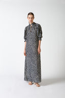 Model wearing Pois Short-Sleeved Long Dress front color navy, made from 100% viscose, styled for a resort look