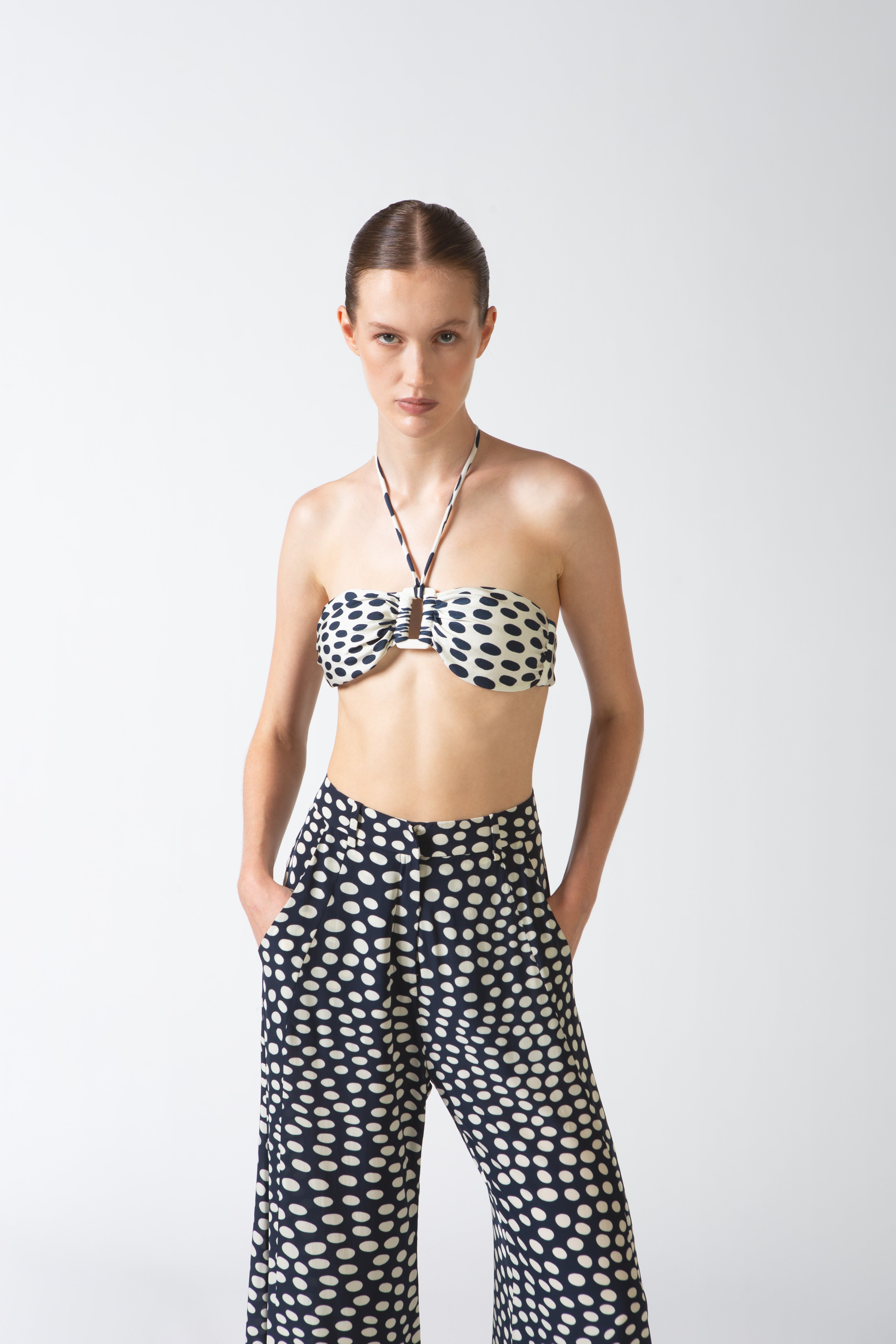Model wearing the Pois Wide-Leg Pants navy detail from the HS25 with 100% viscose styled for a beach look.   