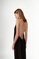 Model wearing the Polka Dots Halter V-Neck Maxi Dress back color black, made with 100% viscose fabric, styled for resortwear look 