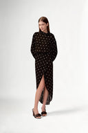 Model wearing the Polka Dots Long Sleeve Maxi Dress look showcasing its black color on 100% Viscose fabric, styled for an evening look.  