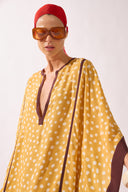 Model waering the Polka Dots Maxi Kaftan detail, showcasing its yellow 100% viscose fabric, styled for a resort look.