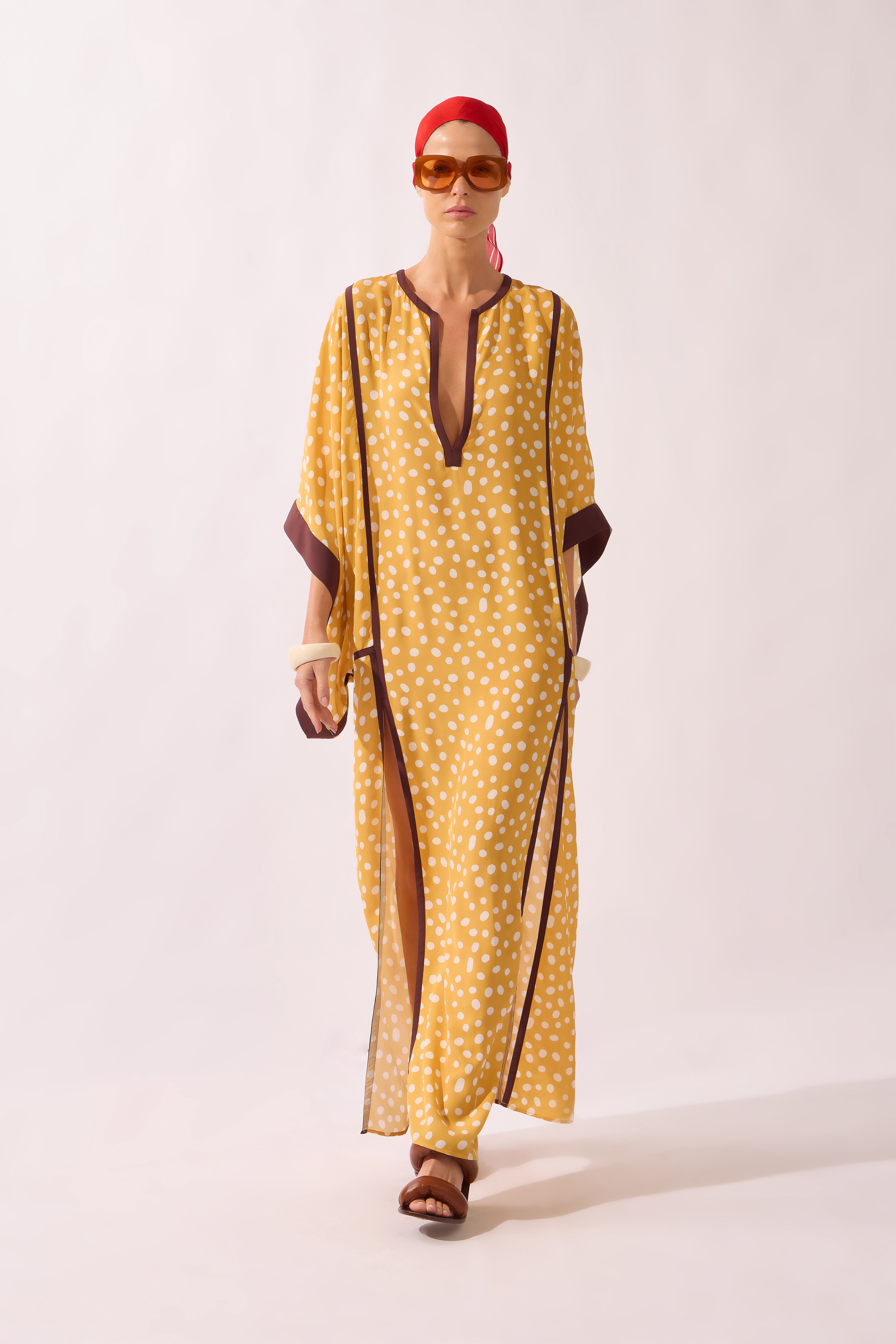 Model waering the Polka Dots Maxi Kaftan front, showcasing its yellow 100% viscose fabric, styled for a resort look.