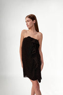 Model wearing the Polka Dots Mini Dress detail color black, made with 100% viscose fabric, styled for resortwear look 