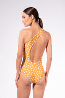 Model wearing the Polka Dots One-Shoulder Swimsuit back color cashew yellow, made from 85% polyamide 15% elastane, styled for a beachwear look