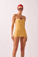 Model wearing the Polka Dots Strapless Sheath front color cashew yellow, made from 85% polyamide 15% elastane, styled for a beachwear look
