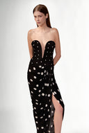 Model wearing the Polka Dots V-Neck Strapless Maxi Dress look showcasing its black color on 100% Viscose fabric, styled for an evening look.  