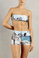 Front view closeup of Adriana Degreas' Postcard Genderless Shorts, featuring a zipper closure and blue postcard print.