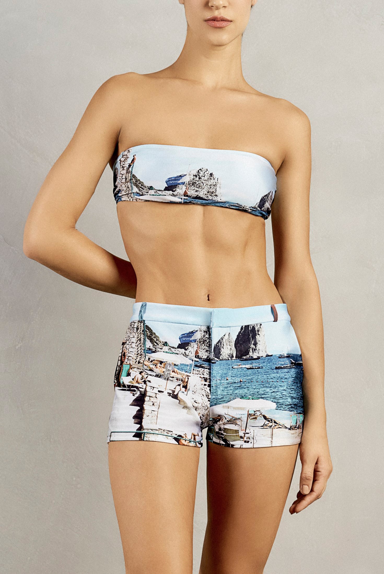 Front view closeup of Adriana Degreas' Postcard Genderless Shorts, featuring a zipper closure and blue postcard print.