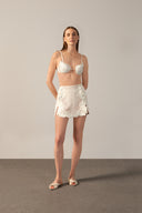 Model wearing theRéseau Appliqué Top Front showcasing its Off White color on 100% cotton fabric.  
