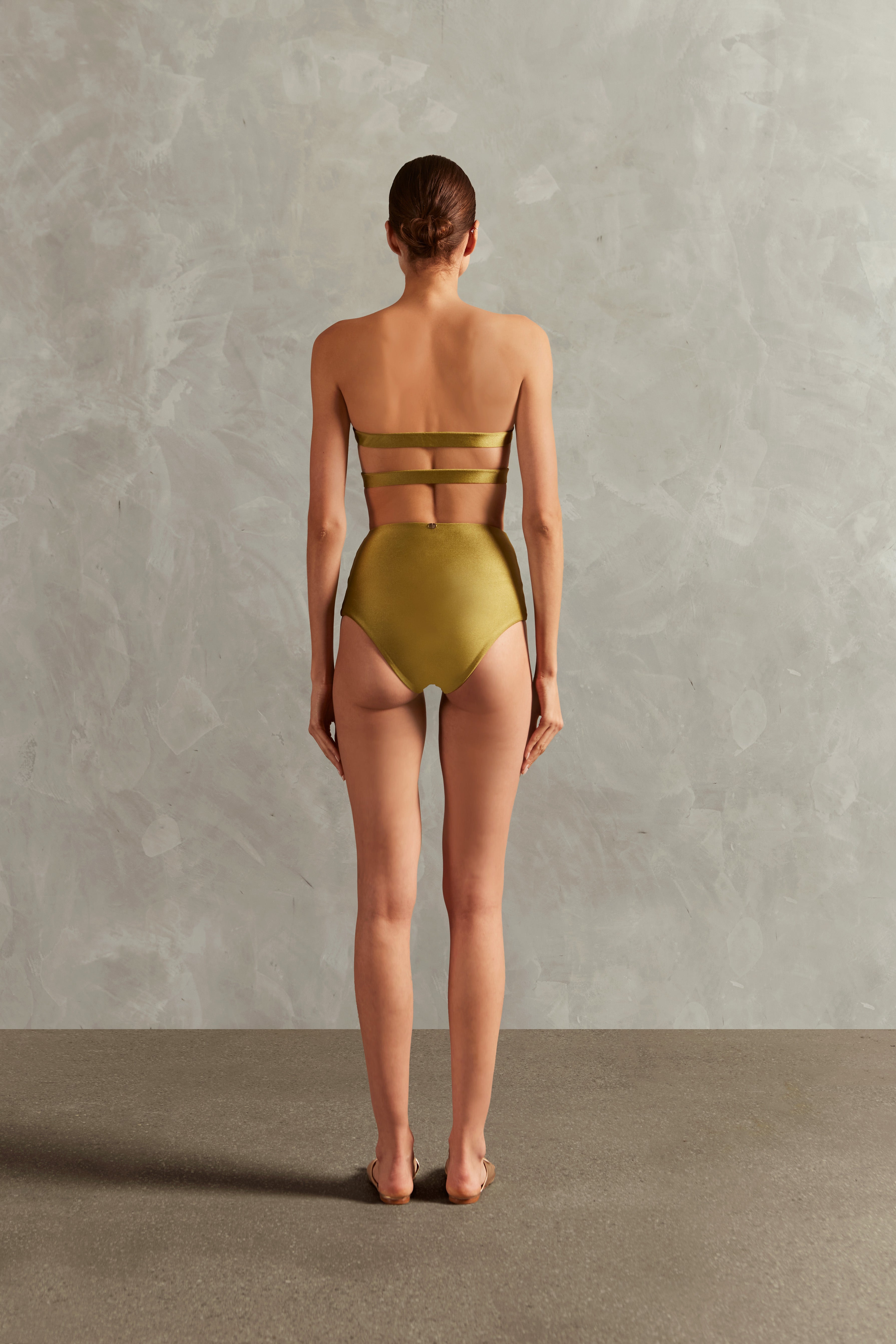 Model wearing the  Réseau Corset Bikini Set Back showcasing its Sugarcane Green color on 85% Polyamide 15% Elastane fabric. 