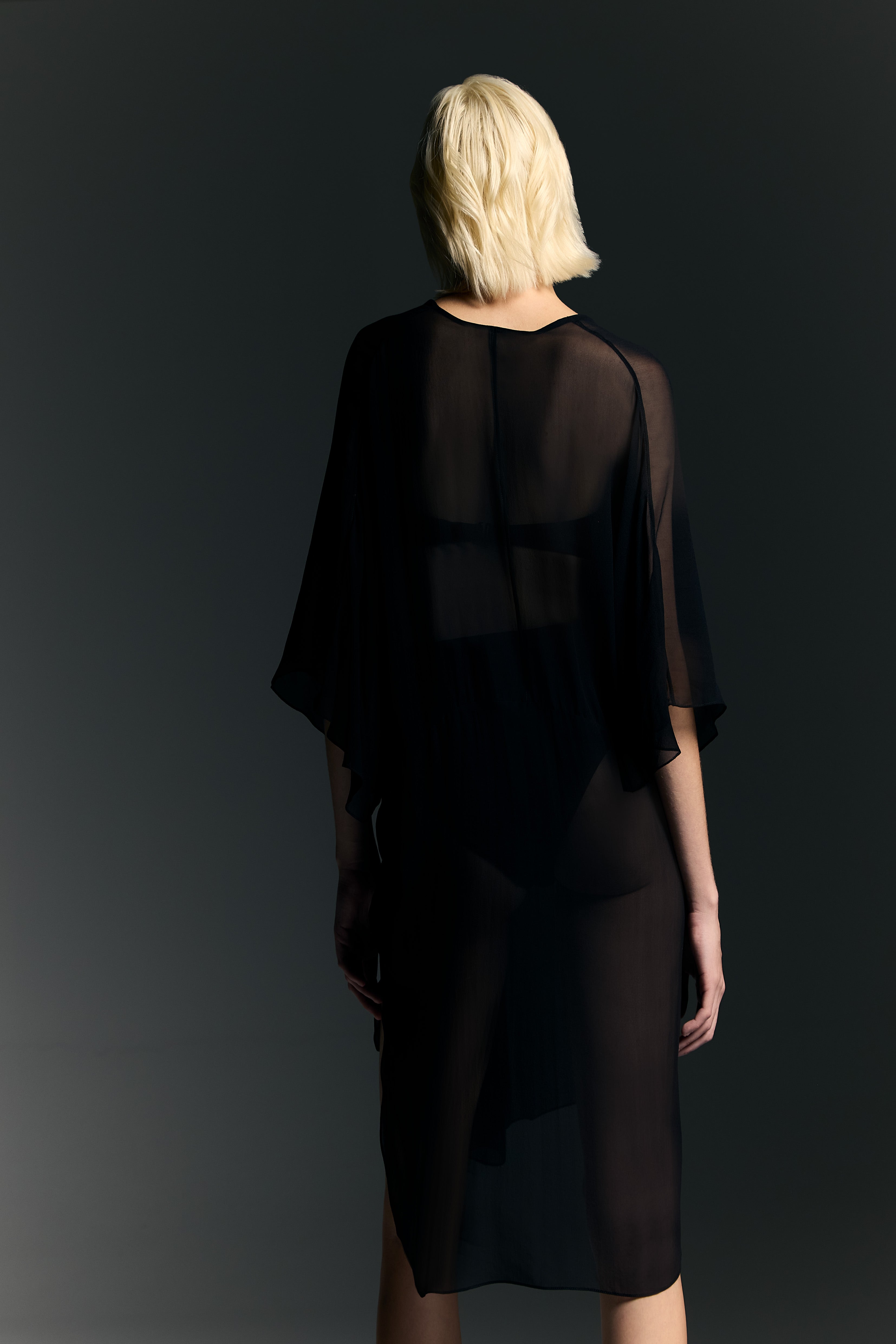 Model wearing the Ruched Sheer Mini Dress back from the Adriana Degreas and Sabine Getty collab with 100% Silk styled for a casual look. 