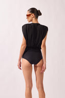 Model wearing the Ruched Swimsuit back color black, made from 100% polyamide, styled for a beachwear look