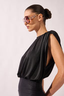 Model wearing the Ruched Swimsuit detail side color black, made from 100% polyamide, styled for a beachwear look