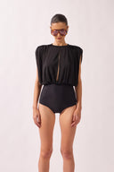 Model wearing the Ruched Swimsuit front color black, made from 100% polyamide, styled for a beachwear look
