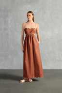 Model wearing the Seashell Solid Cut-Out Long Dress Front color Cognac styled for a resort look