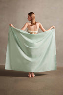 Model wearing the Seashell Print Panneaux Bag Turquoise styled for a resort look