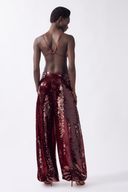 Model wearing the Sequin Bubble Pants color burgundy, made from 100% polyester, styled for a festive look
