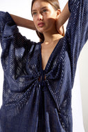 Model wearing the Sequin Front Tie Mini Kaftan detail color navy made from 100% polyester, styled for a soiree look