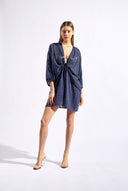 Model wearing the Sequin Front Tie Mini Kaftan look color navy made from 100% polyester, styled for a soiree look