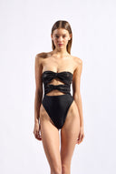 Model wearing the Sequin High-Leg Strapless Swimsuit color black made from 96% polyester 4% elastane, styled for a beachwear look
