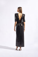 Model wearing the Sequin Peplum Maxi Dress color black made from 100% plyester, styled for an evening look