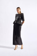 Model wearing the Sequin Peplum Maxi Dress color black made from 100% plyester, styled for an evening look